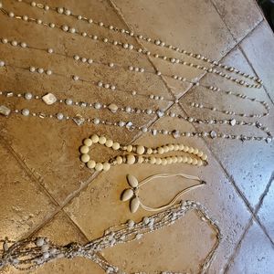 Collection of white, cream, silver snd gold necklaces